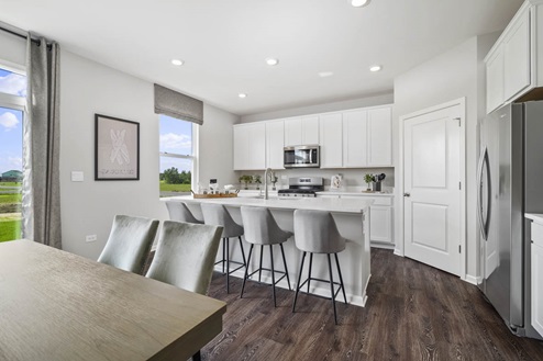 Ivanhoe Holcombe model's open concept kitchen with white cabinets