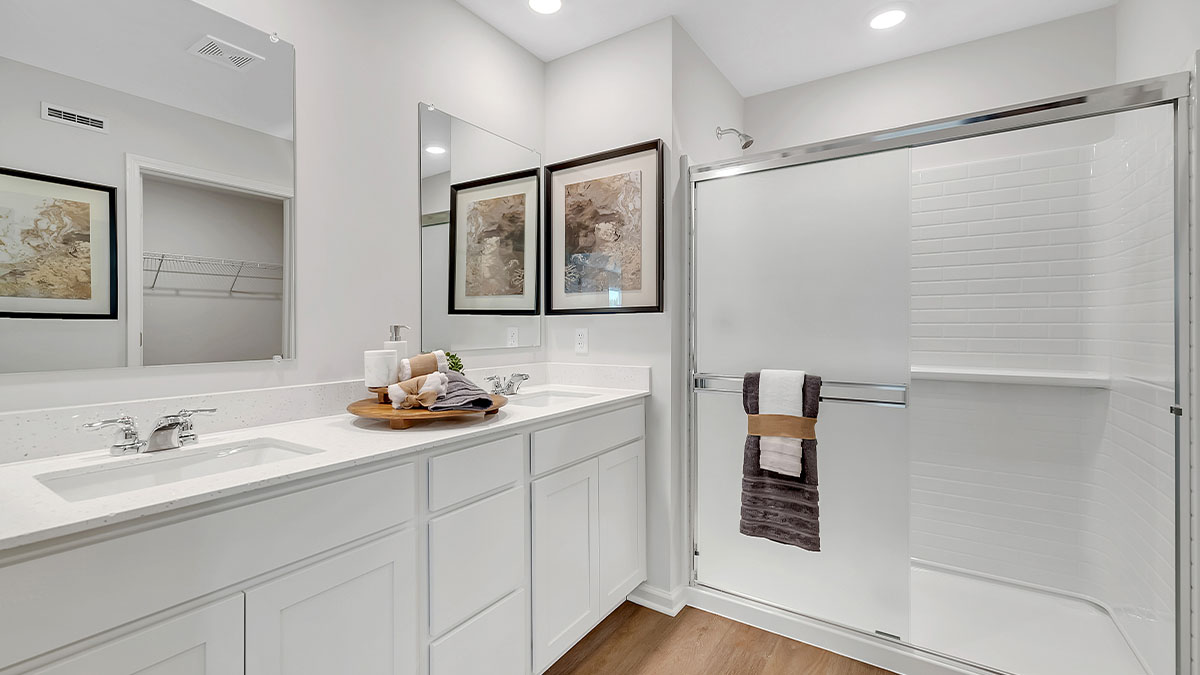 Primary bathroom with dual sinks and walk in shower