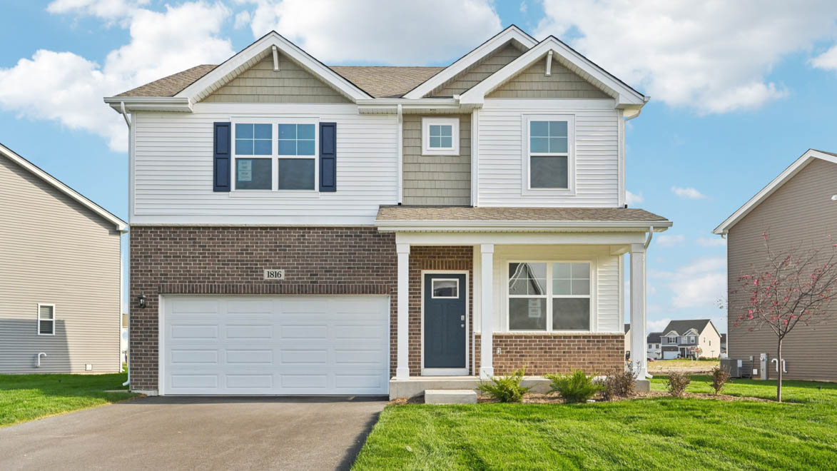 Exterior of two story home with brick and vinyl siding