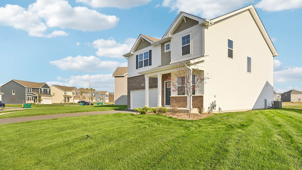 Side view of home with white vinyl siding