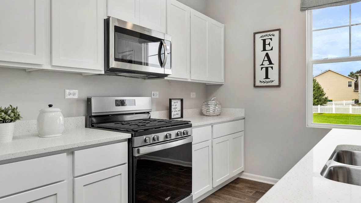 Kitchen with white cabinets and white quartz countertops