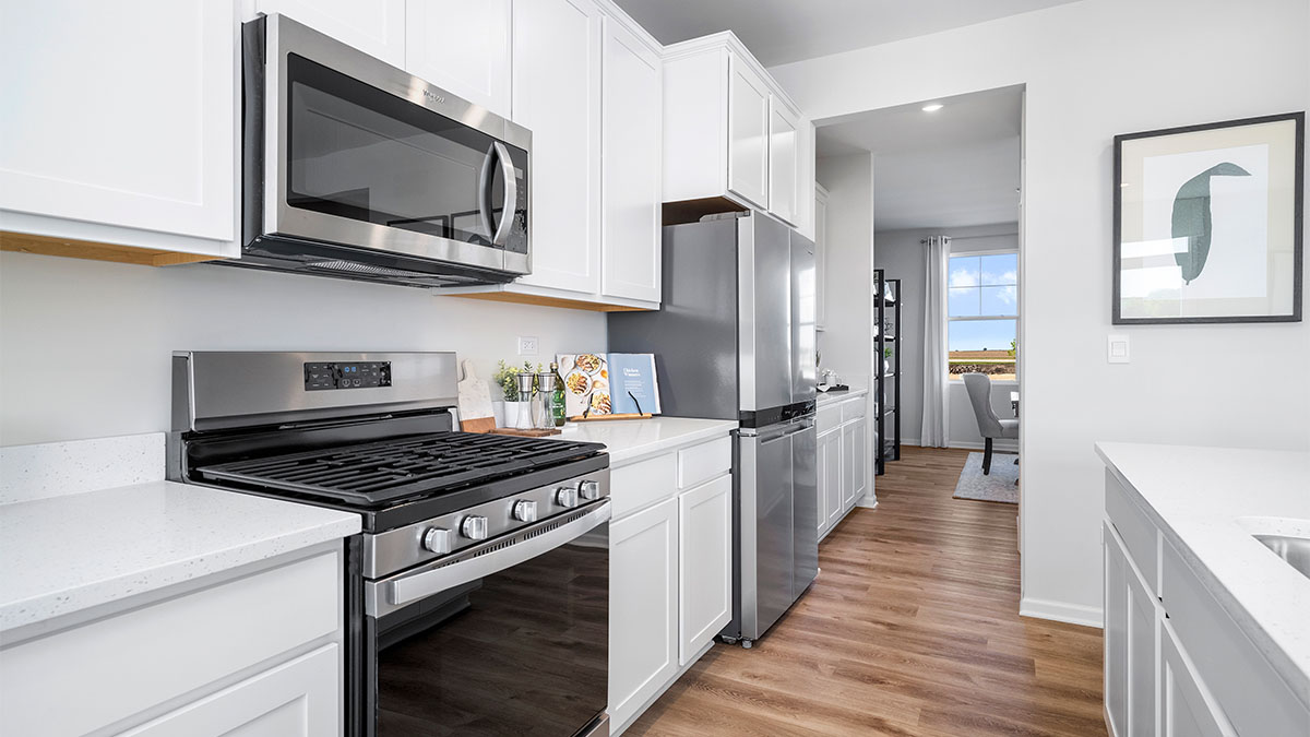 Kitchen with white cabinets and white quartz countertops
