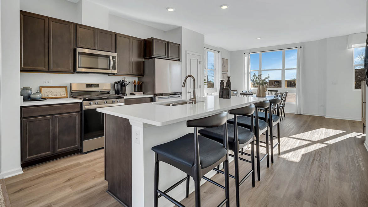 spacious kitchen with large island with overhang