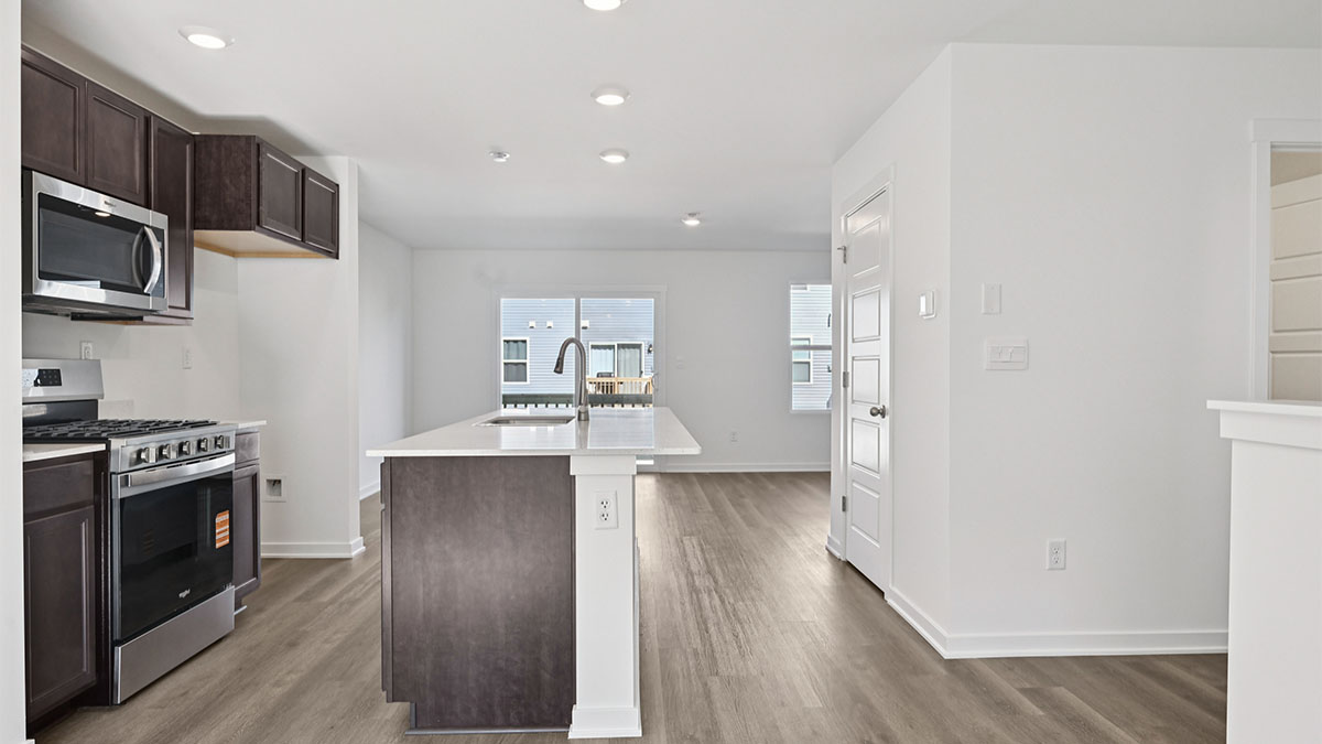 Kitchen with dark cabinets and white quartz countertops