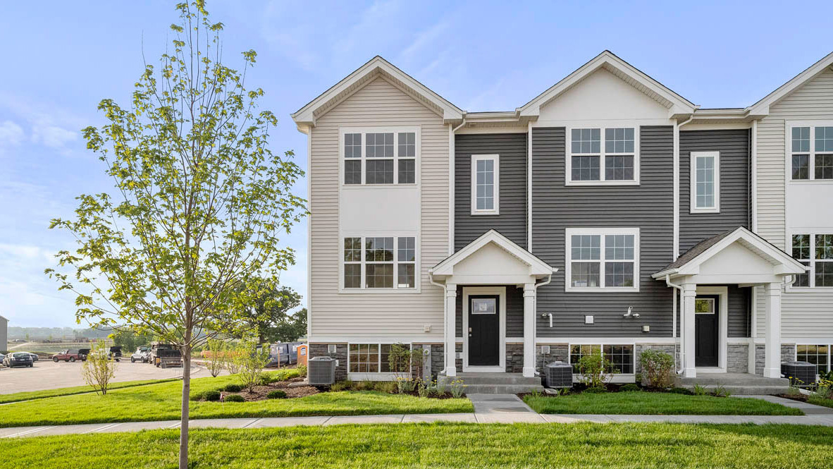 Tri level townhome end unit with vinyl and stone siding
