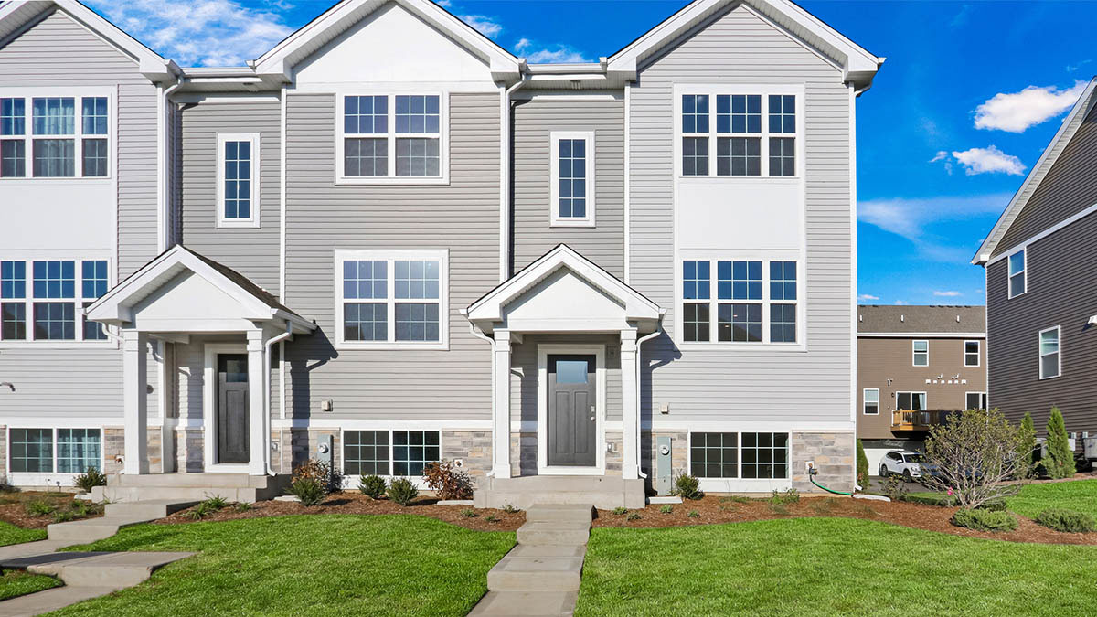 Tri level townhome with vinyl siding and stone accents