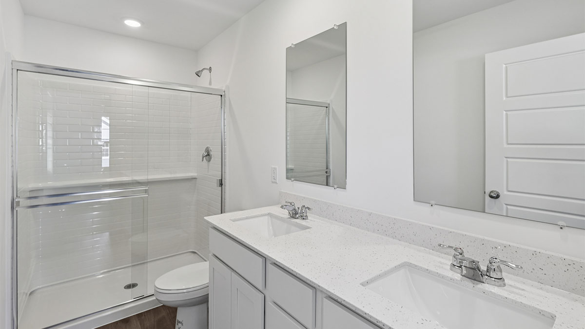 Primary bathroom with dual sinks and walk in shower