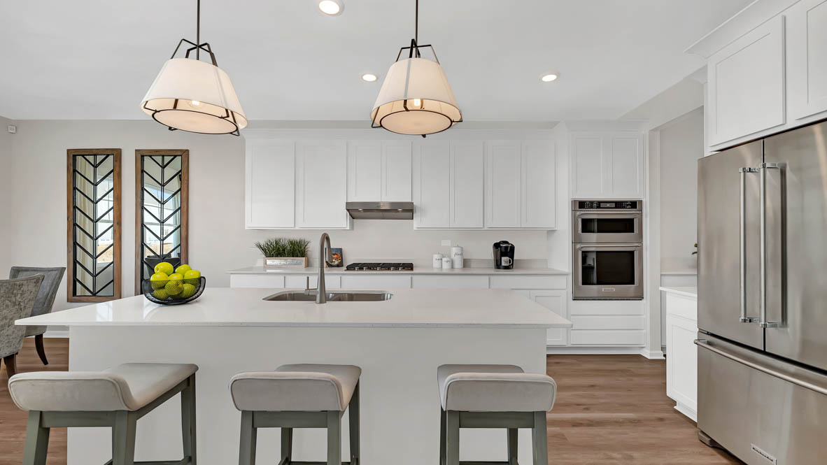 Gourmet kitchen with white cabinets and white quartz countertops