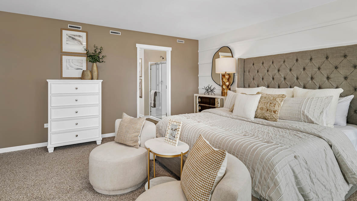 Spacious primary bedroom staged with king size bed