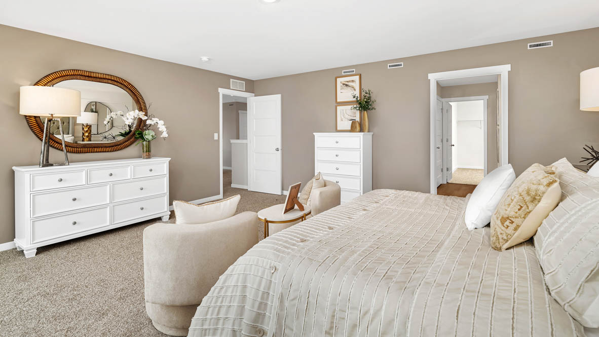 Primary bedroom with carpeting throughout second floor