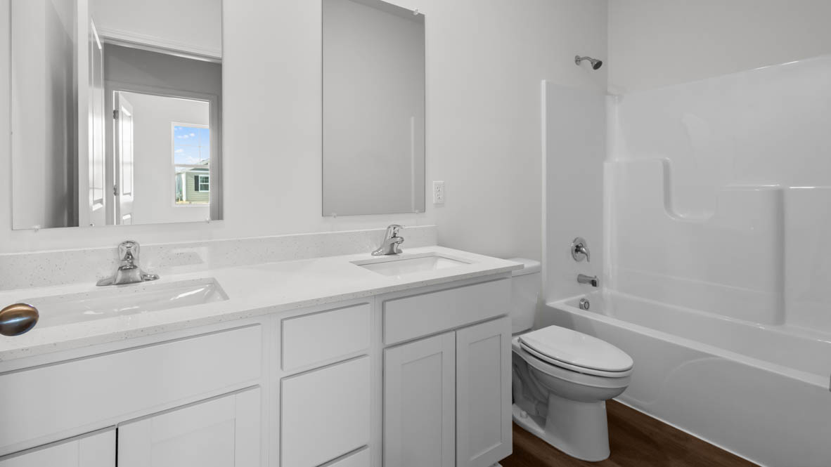 full secondary bathroom with dual sink vanity