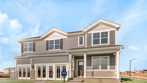 West Point Gardens Emerson Model with a 3 car garage, front porch with rails, and grey vinyl siding with brick accents