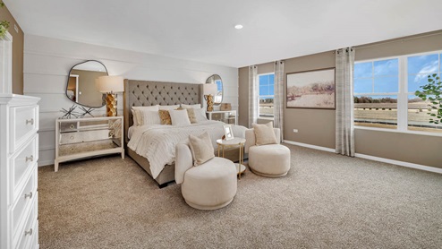 Spacious primary bedroom staged with king size bed