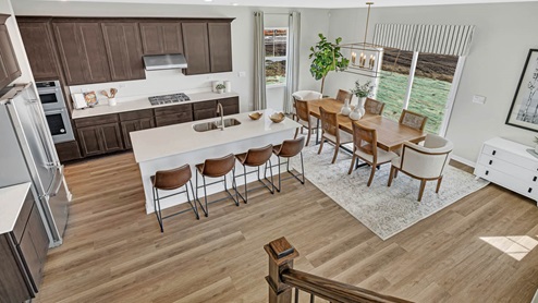 View from staircase to lower level kitchen and dining room