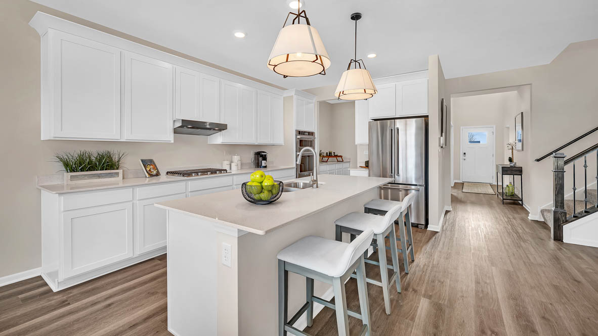 Gourmet kitchen with white cabinets and white quartz countertops