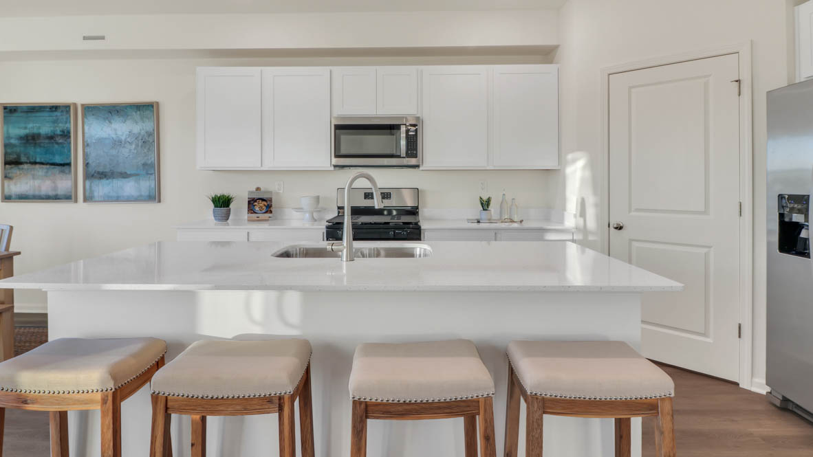 Kitchen with 42 inch white cabinets and white quartz countertops