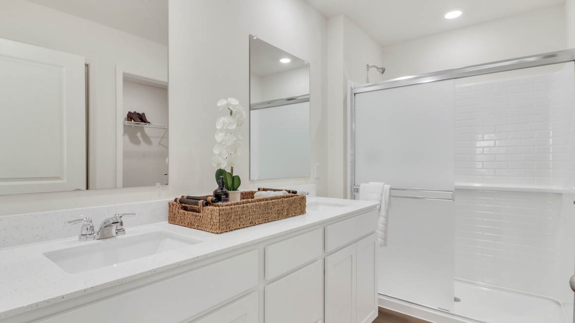 Primary bathroom with dual sinks and walk in shower
