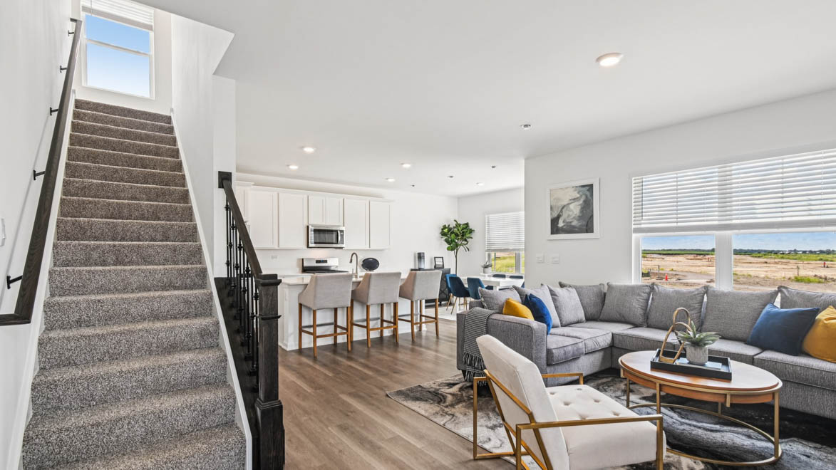 Entry way into open concept living space with great room, kitchen and dining room