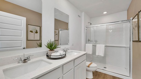 Primary bathroom with dual sinks and walk in shower
