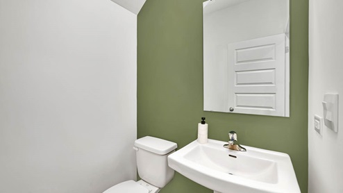 Half bathroom off of mud room from garage entry