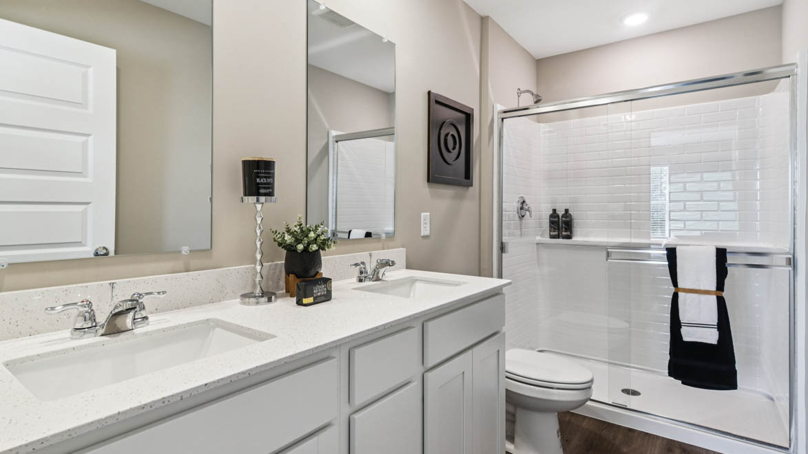 Primary bathroom with dual sinks and walk in shower