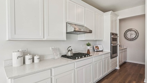 Kitchen with white 42 inch cabinets and white quartz countertops