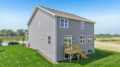Back of home with deck and lookout basememnt