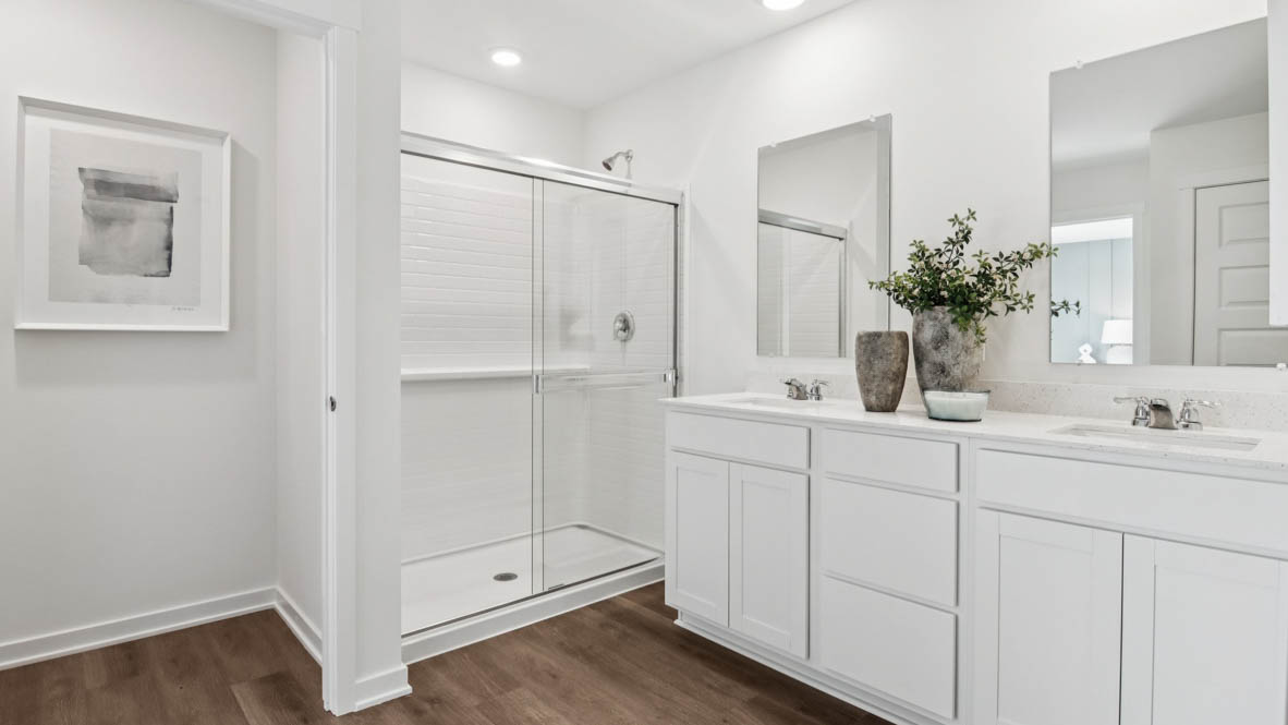 Primary bathroom with dual sinks and walk in shower