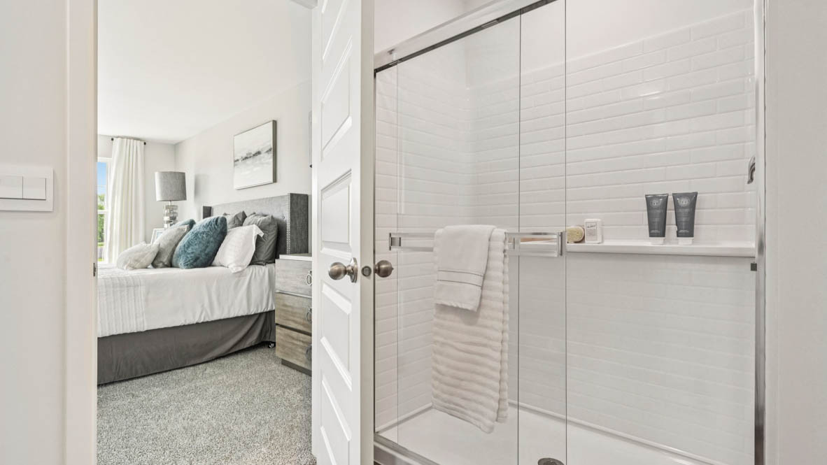 Primary bathroom with dual sinks and walk in closet