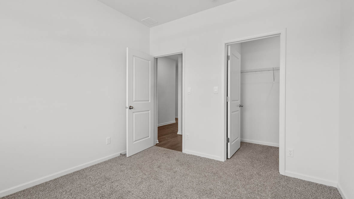 bedroom number 2 with a walk in closet