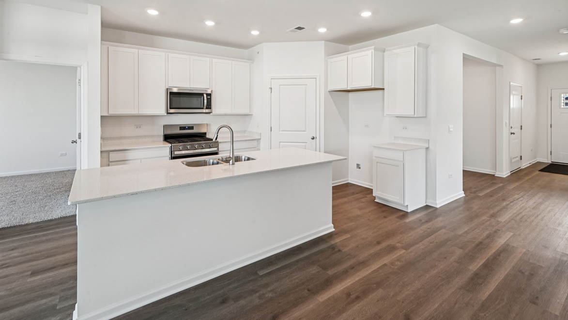 Hallway leading into open area kitchen dining and great room