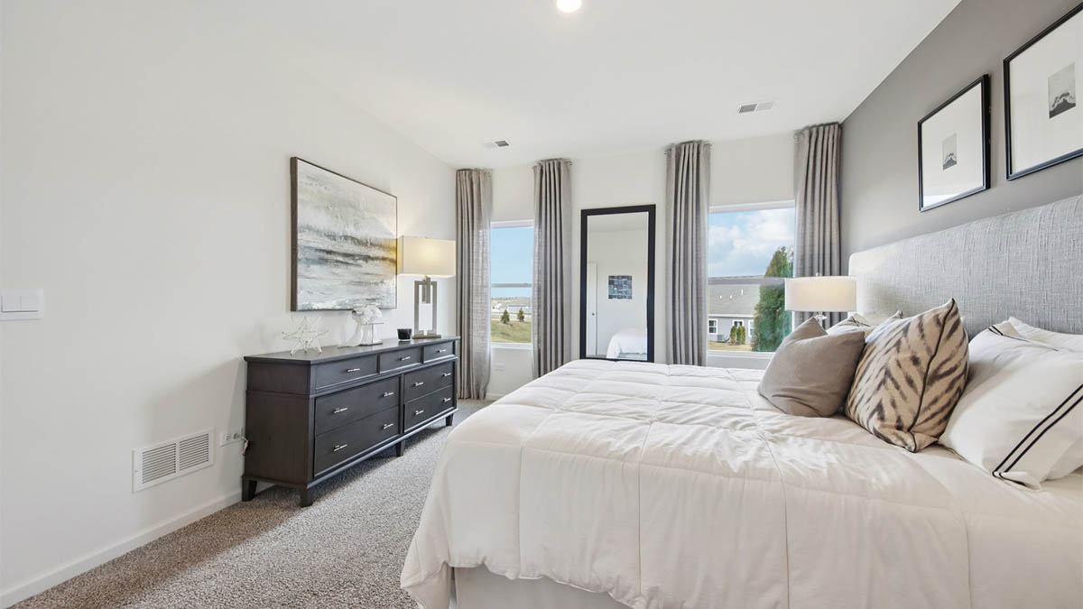 primary bedroom with carpet and large window view