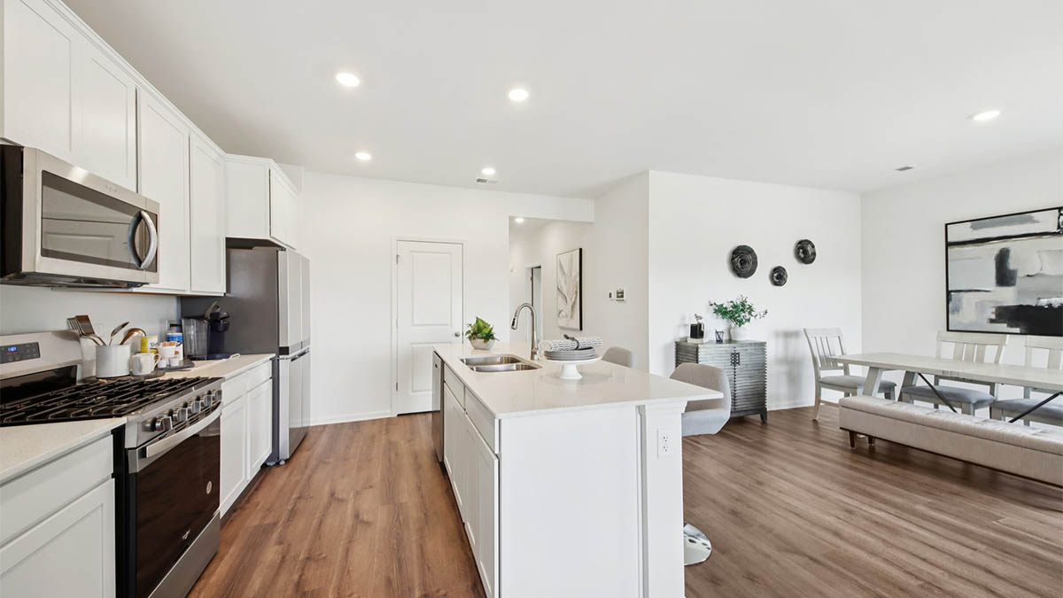 open concept kitchen with spacious island and white cabinets