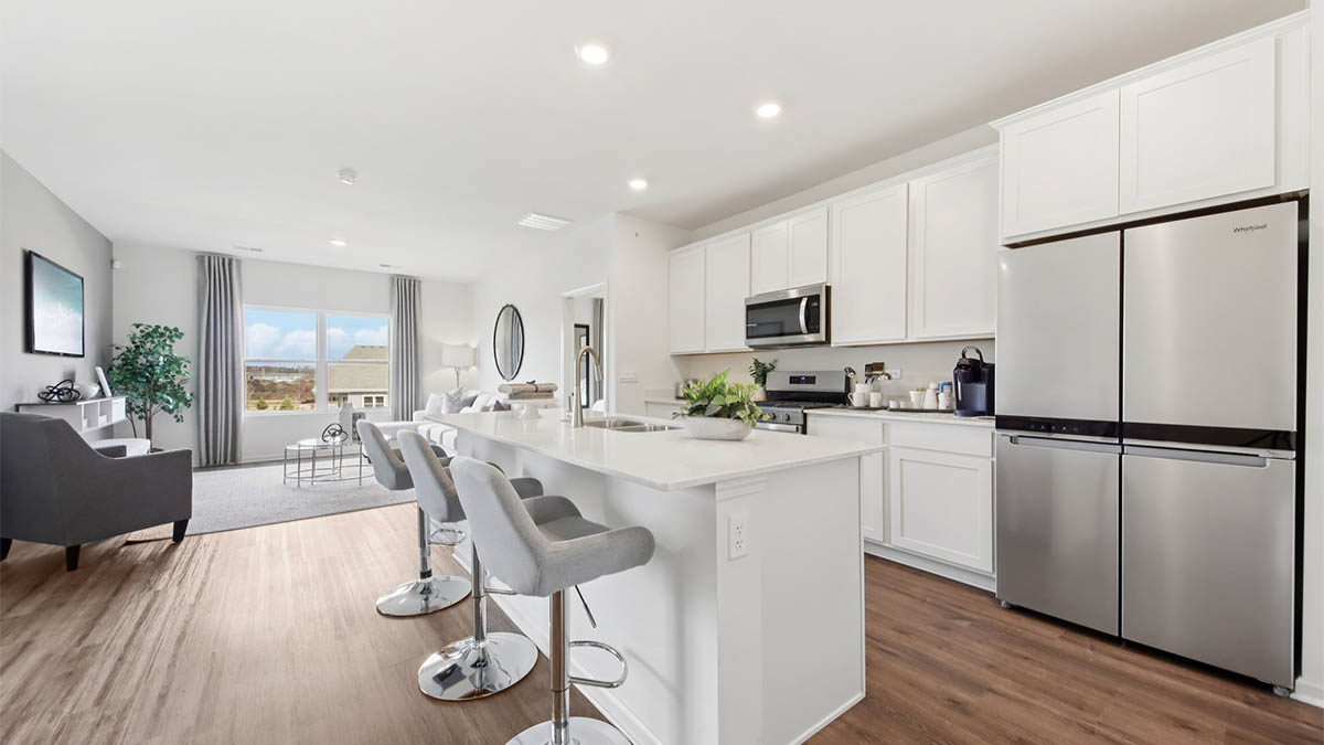 open concept kitchen with spacious island and white cabinets