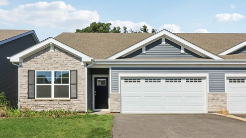 Ranch duplex home with vinyl siding and stone accents