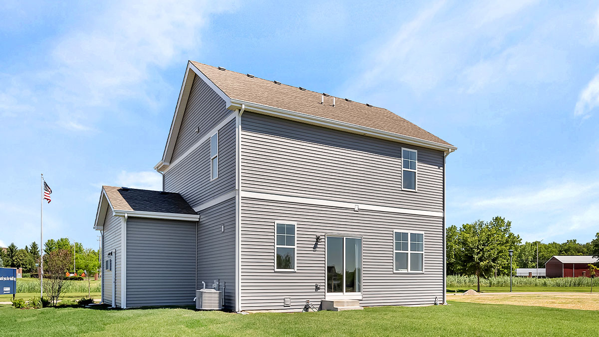Back of home with spacious backyard and full sod