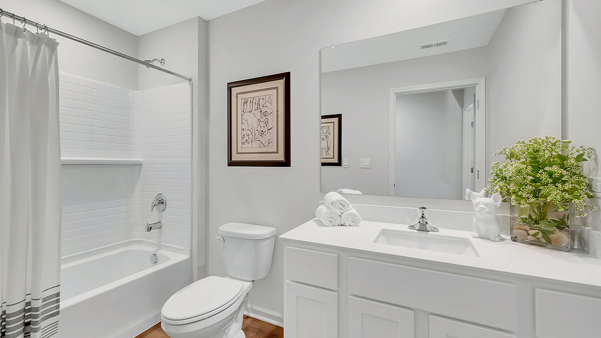 Upstairs full bathroom with quartz vanity and white cabinetry