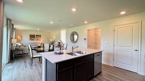 Open concept kitchen with a spacious island overlooking the dining and great rooms
