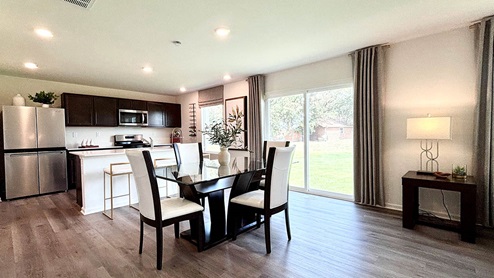 Open concept dining room and kitchen with luxury vinyl plank flooring