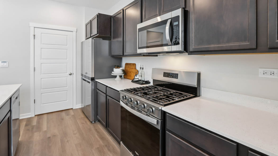 Kitchen with dark cabinets and white quartz countertops