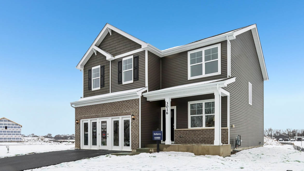 Side view of Bellamy model with brick and vinyl siding and a front porch