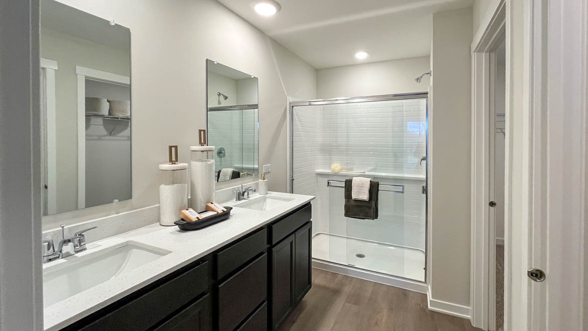Primary bathroom with dual sinks and walk in shower