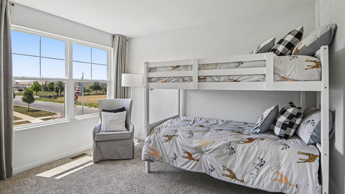 secondary bedroom with carpeted flooring and window