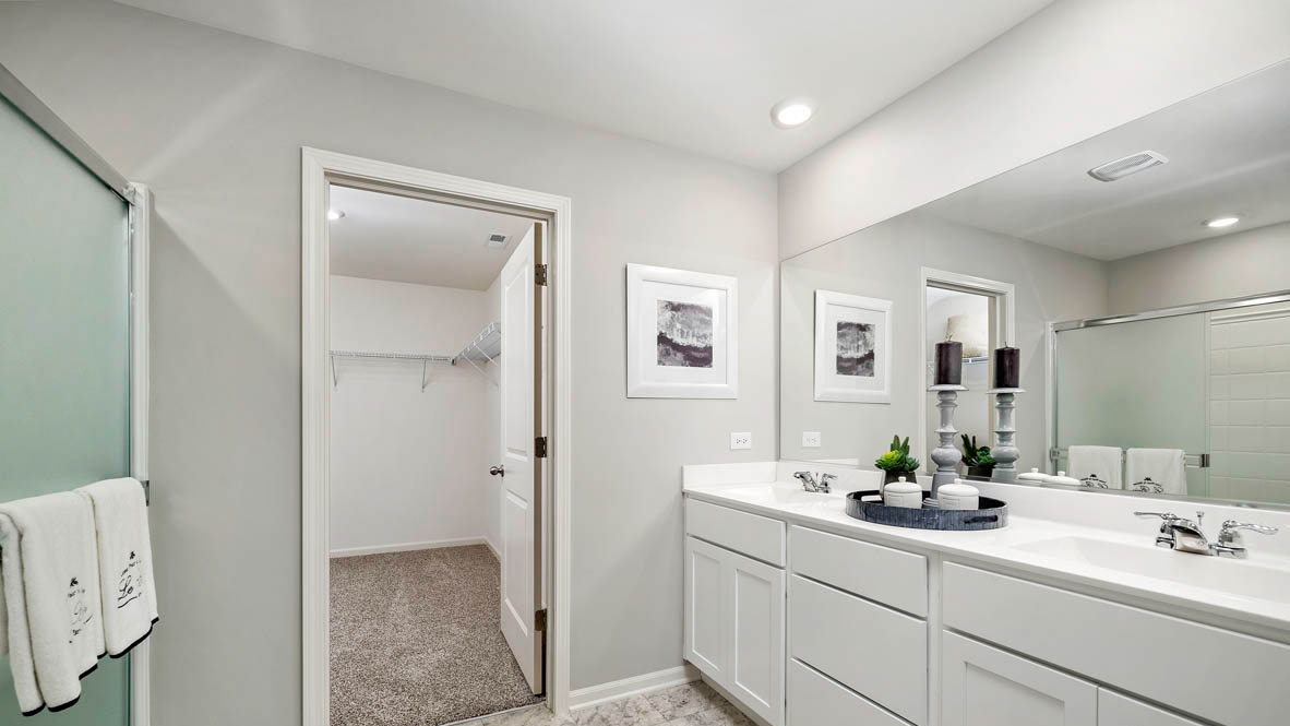 primary bedroom with dual bowl vanity