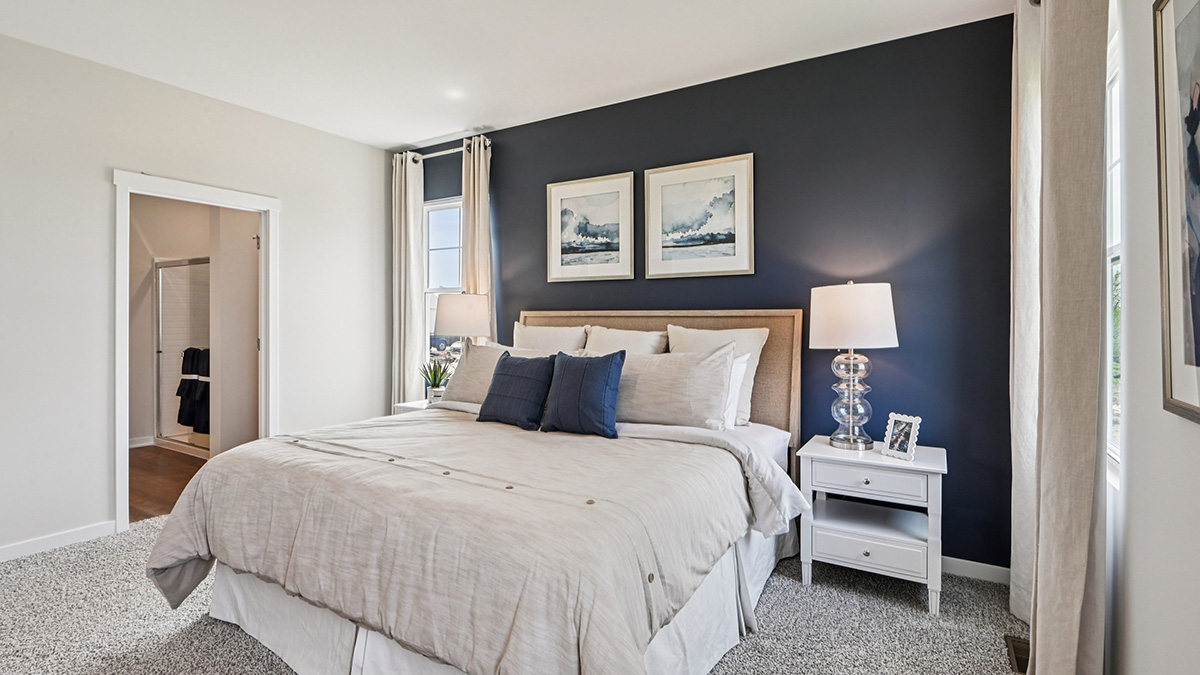 primary bedroom with carpet and large window view