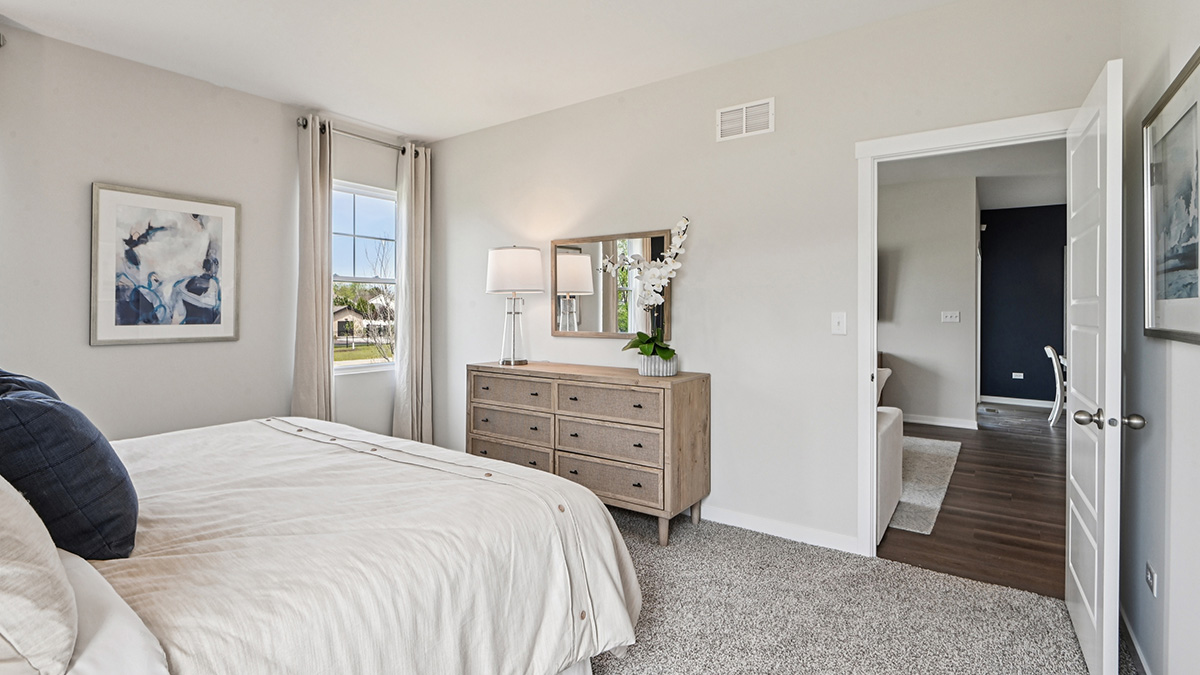 primary bedroom with carpet and large window view