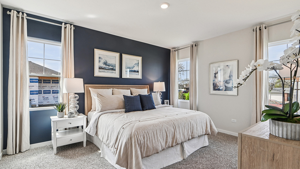 primary bedroom with carpet and large window view