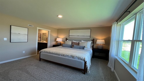 Primary bedroom with carpeting