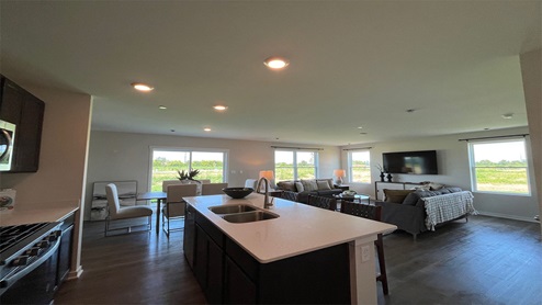 Open concept kitchen with dark cabinetry