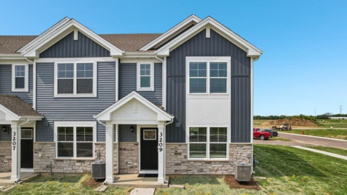 Two story townhome with stone and vinyl siding